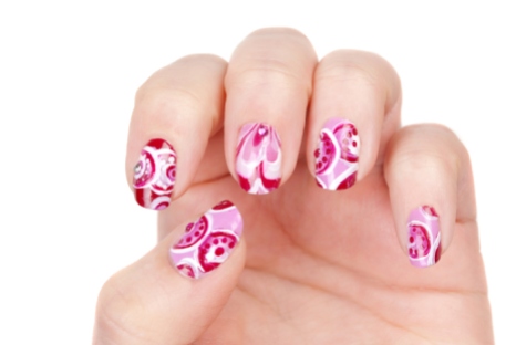 Woman hands with art modern pink abstract manicure isolated on the white